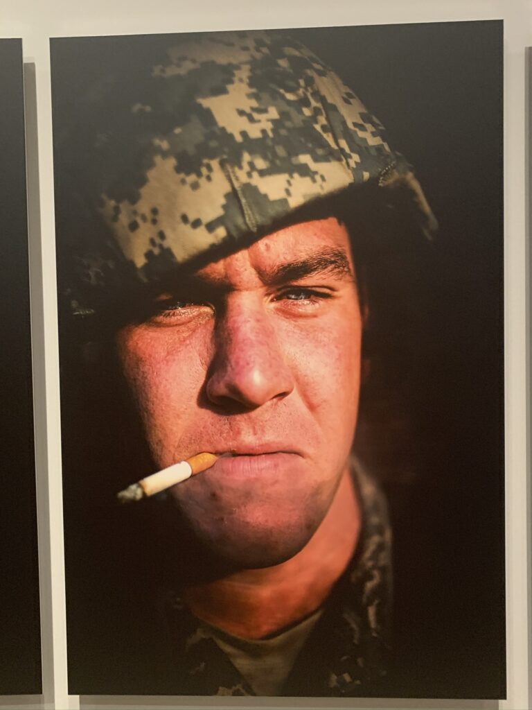 Portrait of a man in military uniform at sunset, a half smoked cigarette in his mouth, ©Stacy Pearsall